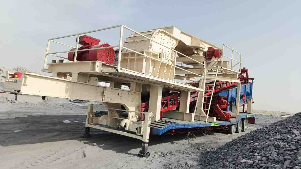 Heavy duty mobile track crusher unit operating inside an active UAE quarry site